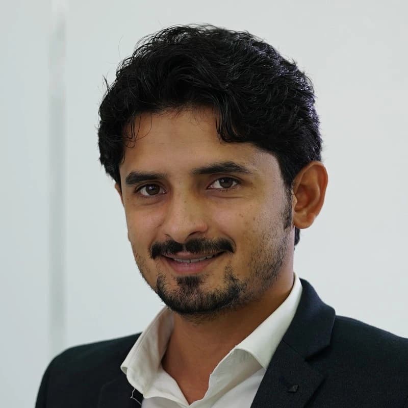 Ali Raza, owner of High Range Garage, in a dark blazer and white shirt